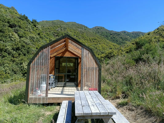 Wooden cabin in a mountainous area with a clear blue sky